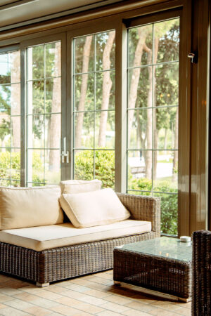 outdoor sofa with beige cushions and coffee table in front of the restaurant window